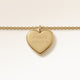 Close-up of minimalist heart-shaped heart pendant in gold with smooth surface and space for personalized engraving on the front and back