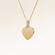 Personalized heart-shaped gold necklace with white zircons and space for engraving of text, coordinates or handwriting on the front and back