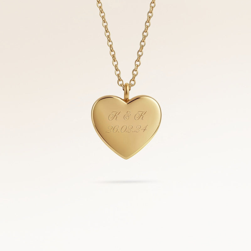 Personalized heart-shaped gold necklace with space for engraving of text, coordinates or handwriting on the front and back