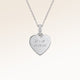 Close-up of minimalist heart-shaped heart pendant in silver with white zircons and space for personalized engraving on the front and back