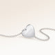Back of a heart-shaped silver necklace with a personal engraved date
