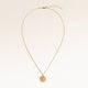 Full round gold necklace laid out flat with a fine adjustable gold chain and a minimalist round pendant for personal engraving