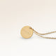 Personalized round gold necklace with space for engraving of text, coordinates or handwriting on the front and back