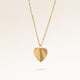 Minimalist heart-shaped gold necklace with sunburst pattern and space for engraving of text, coordinates or handwriting on back.