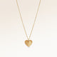 Personalized heart-shaped gold necklace with ribbed sunburst pattern centered and minimalist pendant with space for engraving on back.
