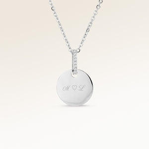 Personalized round silver necklace with white zircons and space for engraving of text, coordinates or handwriting on the front and back