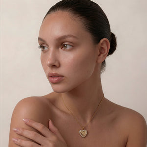 Personalized heart-shaped gold necklace with white zircons along the edge and space for engraving of 8 characters on one line on the front