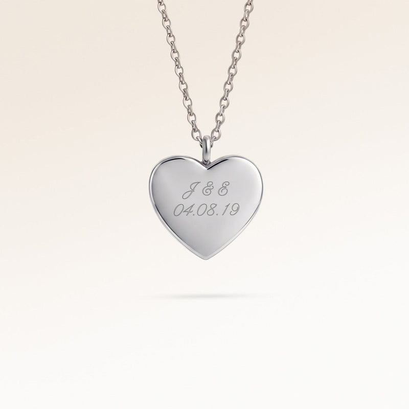 Personalized heart-shaped silver necklace with space for engraving of text, coordinates or handwriting on the front and back