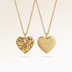 Personalized heart-shaped gold necklace with softly melted finish and space for engraving of text, coordinates or handwriting on the back