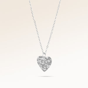 Heart-shaped silver necklace with rippled wave surface side view, space for engraving on back