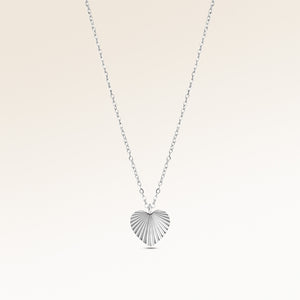 Personalized heart-shaped silver necklace with ribbed sunburst pattern and space for engraving of text, coordinates or handwriting on the back
