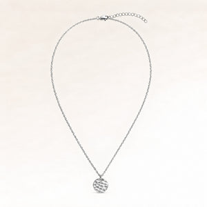 Full round silver necklace laid out flat with a fine adjustable silver chain and a minimalist round pendant for personal engraving